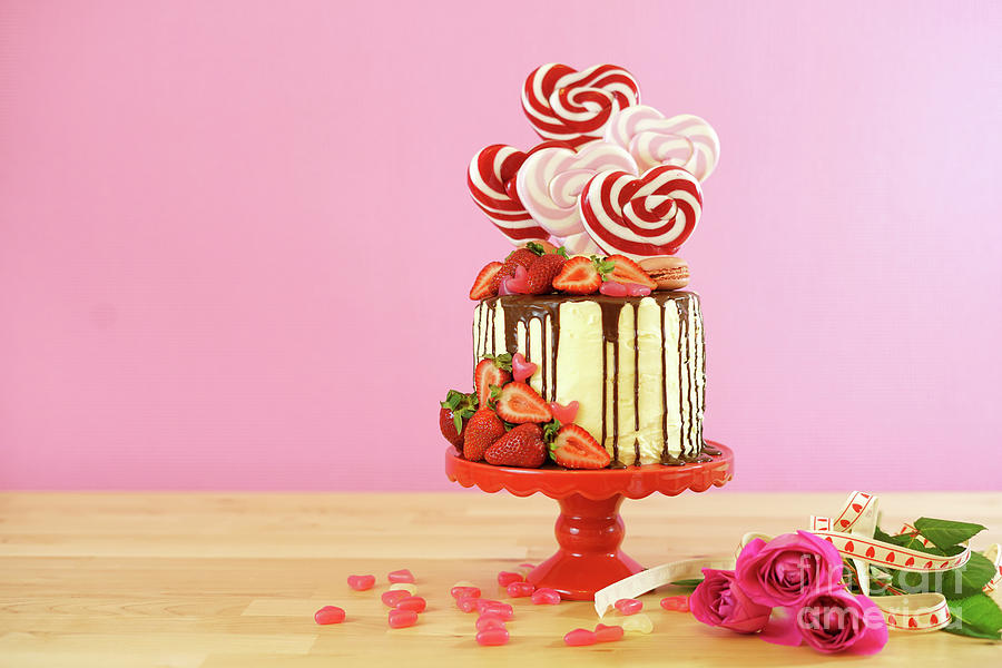 Valentines Day candyland drip cake decorated with heart shaped lollipops. #6 Photograph by Milleflore Images