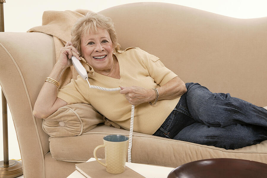 Woman talking on telephone #6 Photograph by Comstock Images
