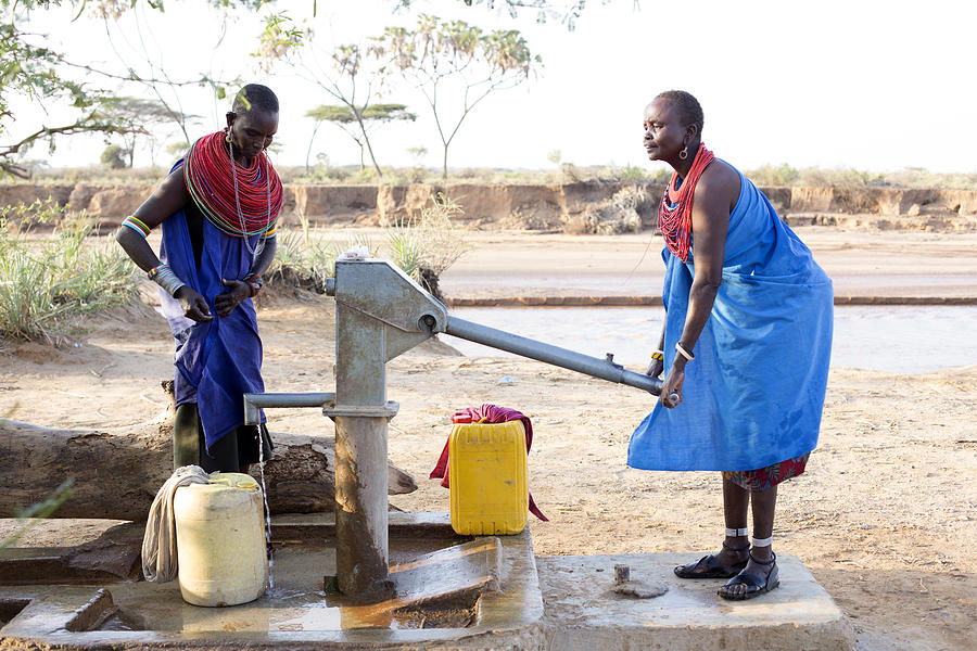 Women collecting clean water from borehole in desert. Samburu. Kenya. #6 Photograph by Hugh Sitton