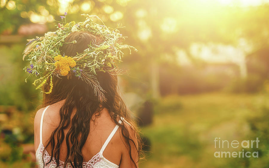 Women in flower wreath on sunny meadow, Floral crown, symbol of