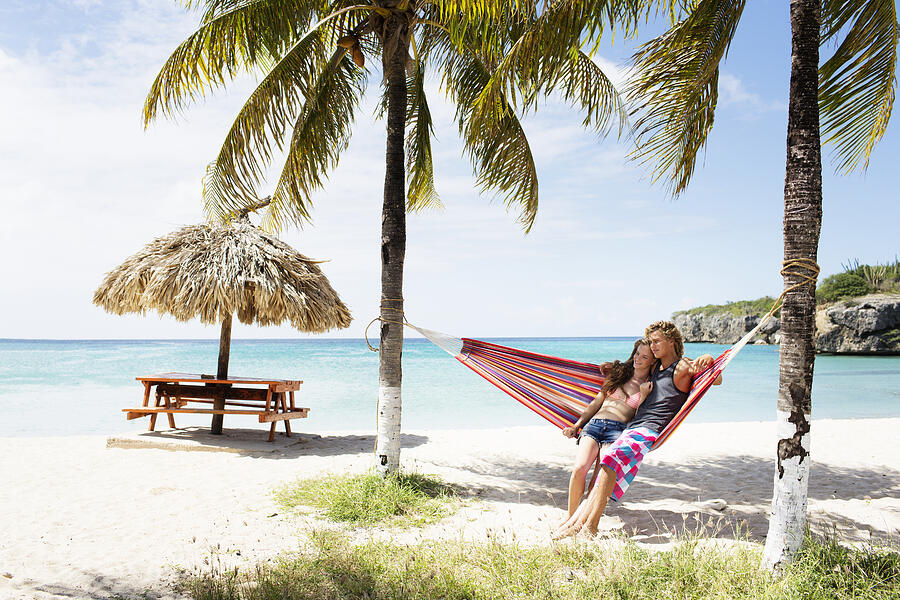 Young couple relaxing in hammock on beach #6 Photograph by Felix Wirth