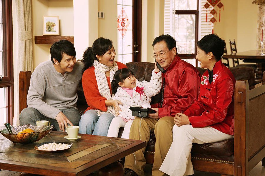 Family celebrating Chinese New Year #7 Photograph by View Stock