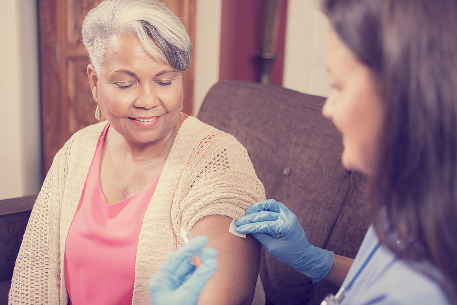 Home healthcare nurse giving injection to senior adult woman. #7 Photograph by Fstop123
