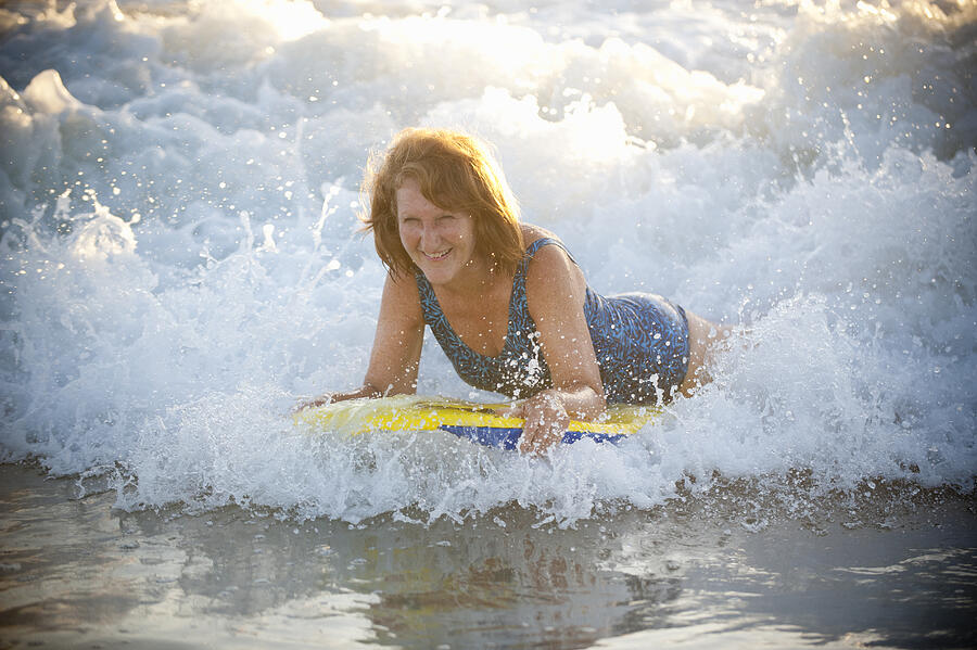 Senior Woman At The Beach With Her Body Board #7 Photograph by Stephen Simpson