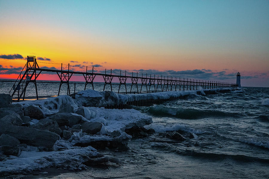 Sunset at Manistee Pier and Lighthouse in Manistee Michigan during the winter #7 Photograph by Eldon McGraw