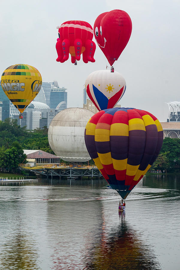 Cloudy morning view with hot balloons over lake Putrajaya, Malaysia. #8 Photograph by Shaifulzamri