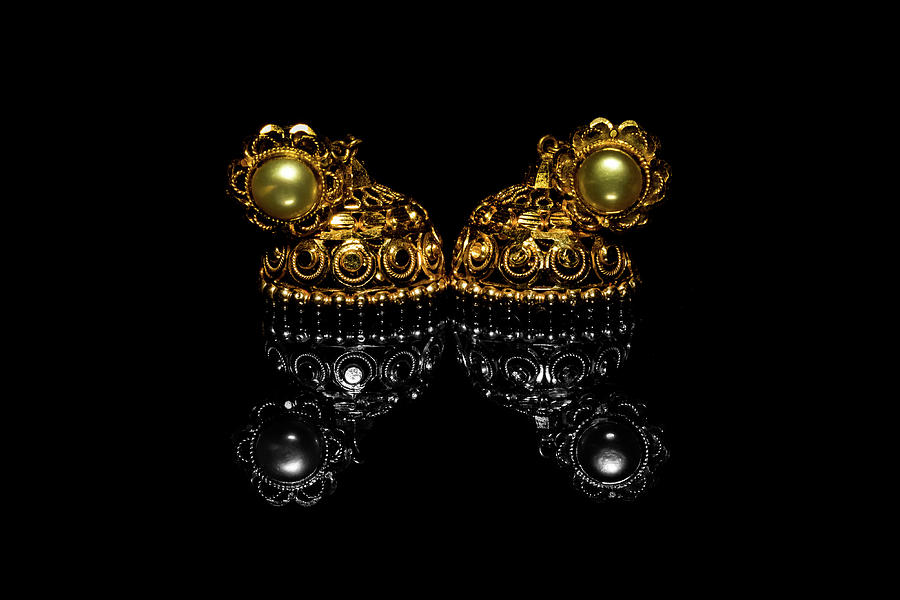 Earring Gold Jewelry Traditional With Stones and Two Golden earrings with  reflection . Pair of golden earring with pearl tone on black background.  Luxury female jewelry, close-up Jewelry by Srinivasan Jayaprakash -