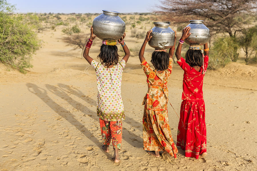 Indian little girls carrying on their heads water from well #8 Photograph by Bartosz Hadyniak