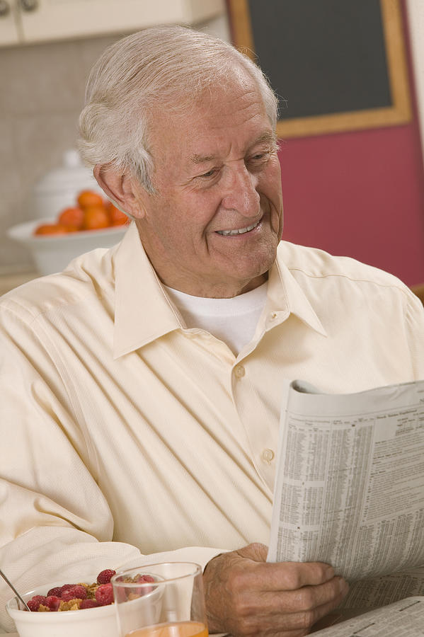 Man reading newspaper #8 Photograph by Comstock Images