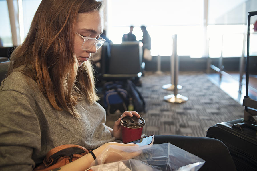 Millennial woman traveling in airport. #8 Photograph by Martinedoucet