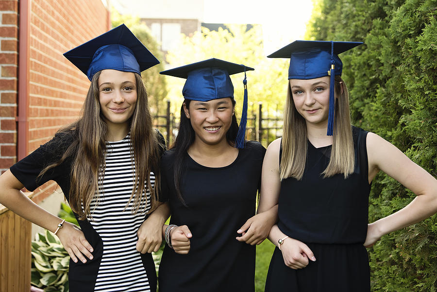 Teenage girls graduation from primary school portrait in backyard. #8 Photograph by Martinedoucet