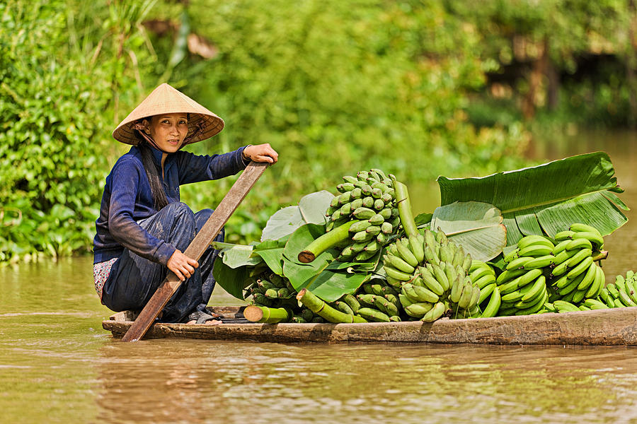 Vietnamese woman rowing  boat in the Mekong River Delta, Vietnam #8 Photograph by Hadynyah