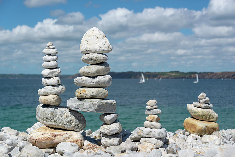 Balancing rocks on a beach Photograph by Delphimages Photo Creations