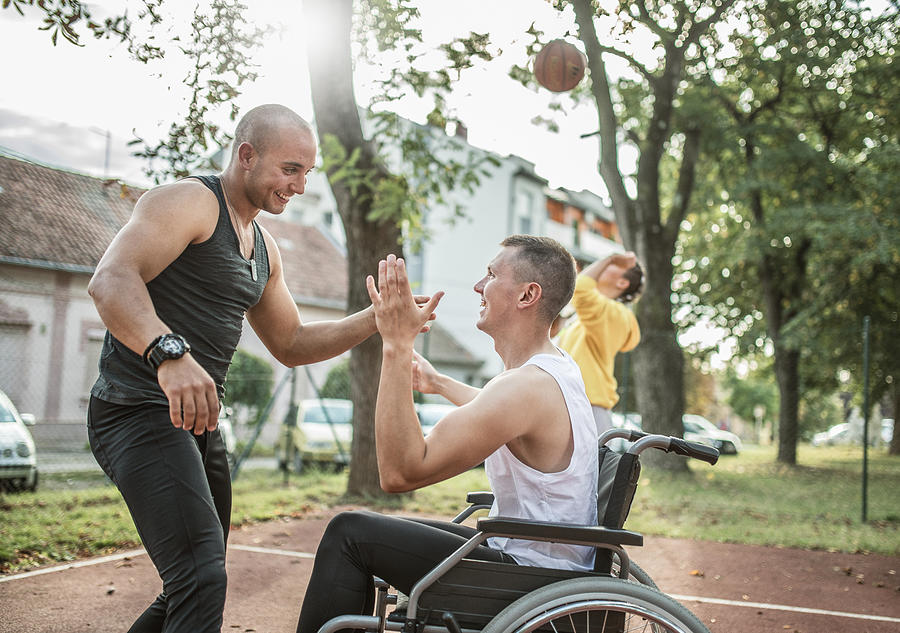 Disabled men playing basketball with friends #9 Photograph by Zeljkosantrac