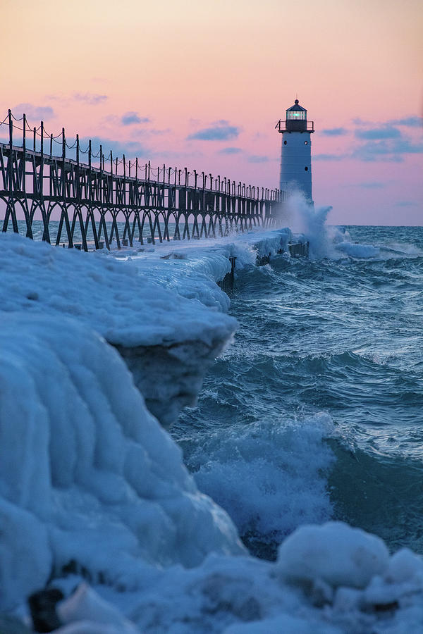 Sunset at Manistee Pier and Lighthouse in Manistee Michigan during the winter #9 Photograph by Eldon McGraw