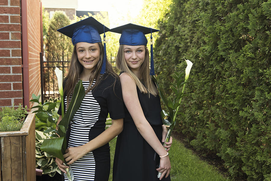 Teenage girls graduation from primary school portrait in backyard. #9 Photograph by Martinedoucet