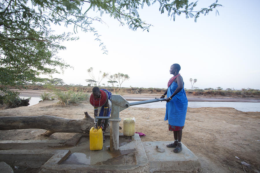 Women collecting clean water from borehole in desert. Samburu. Kenya. #9 Photograph by Hugh Sitton