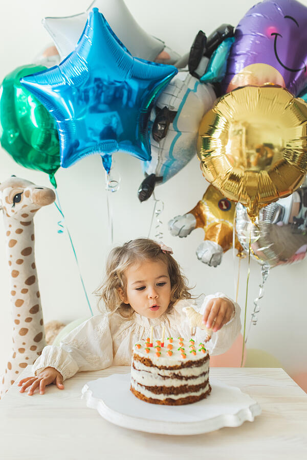 Young girl blowing candles for celebreating her 2th years birthday. #9 Photograph by Anastasiia Krivenok