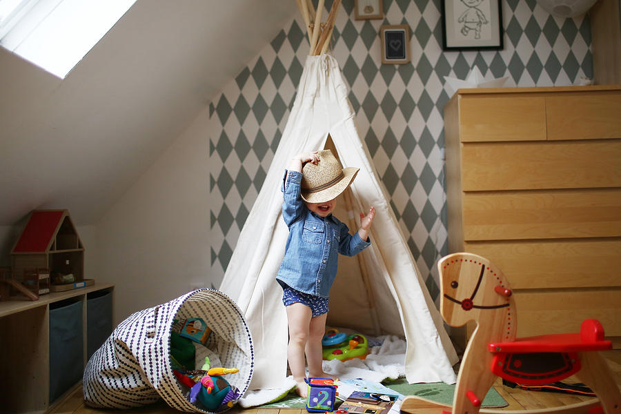 A 2 years old boy playing in his bed Photograph by Catherine Delahaye
