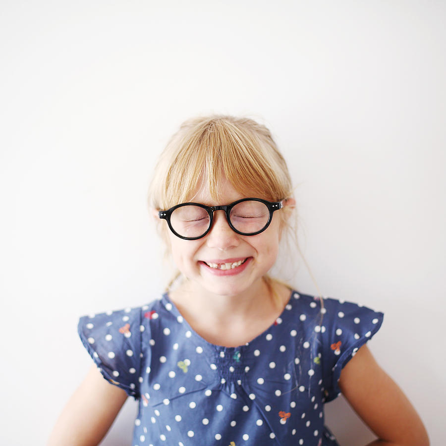 A 8 years old girl with glasses Photograph by Catherine Delahaye