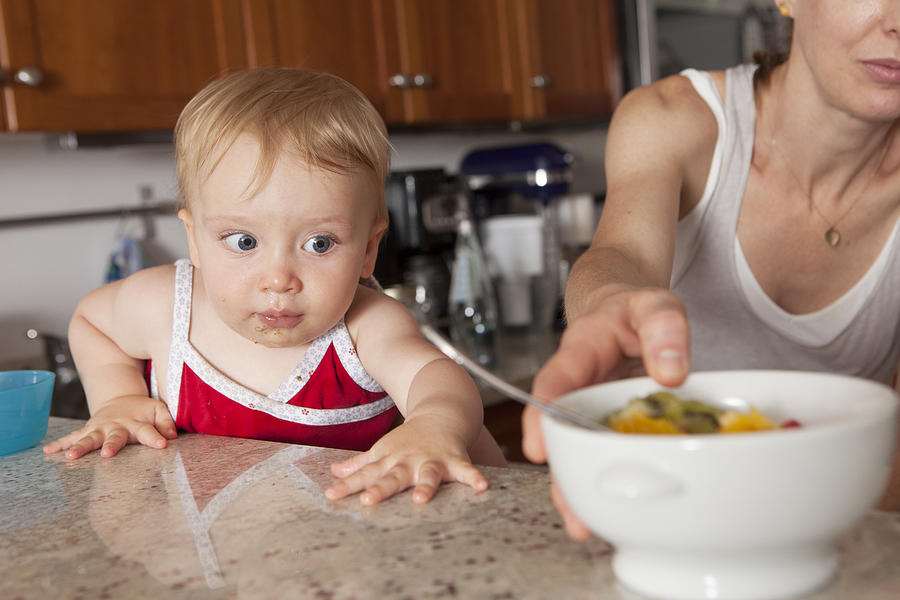 A baby about to reach for a bowl of fruit Photograph by Carey Kirkella