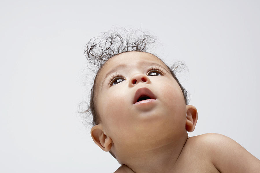 A baby boy looking up Photograph by OJO Images