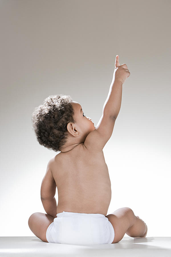 A baby boy pointing Photograph by Image_Source_