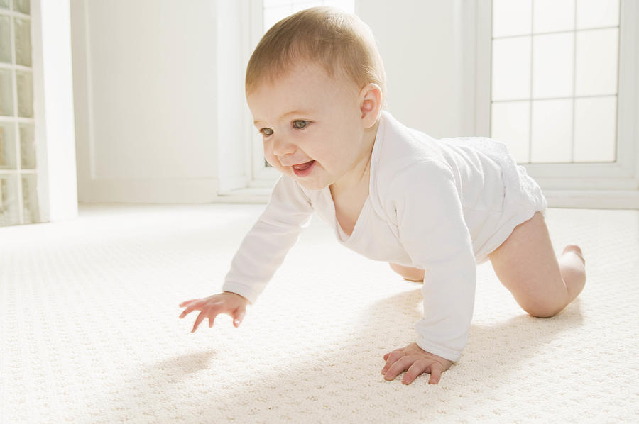 A baby crawling Photograph by Tickle Images