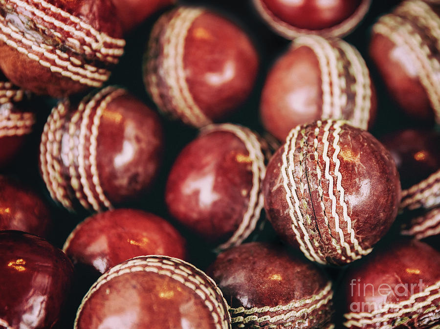 A background of vintage red leather cricket balls with white sti Photograph by Jane Rix