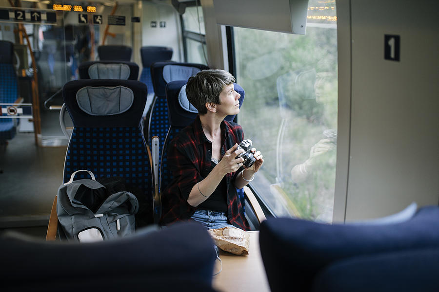 A Backpacker Enjoying The Scenery During A Train Journey Photograph by Willie B. Thomas