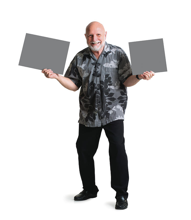A Bearded Elderly Caucasian Man In A Hawaiian Shirt Holds Two Signs On Either Side Of Himself Photograph by Photodisc