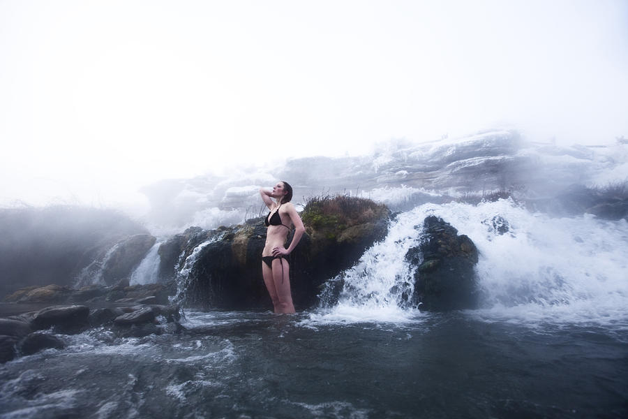 A beautiful woman standing in a hot springs waterfall in Montana. Photograph by Patrick Orton