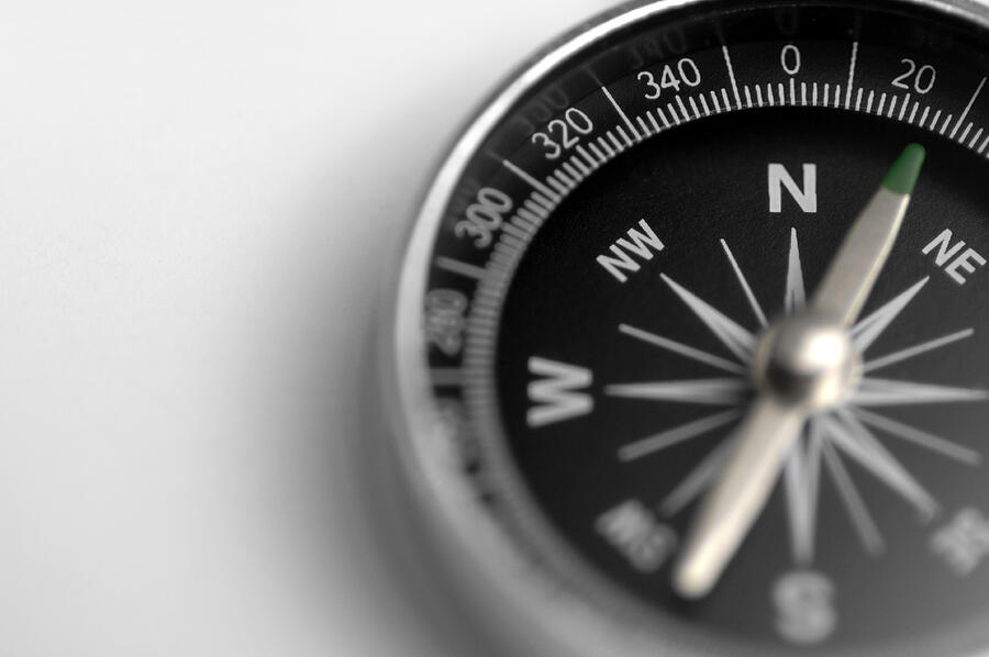 A black and silver compass on a white background Photograph by Peepo A black and silver compass on a white background Photograph by Peepo