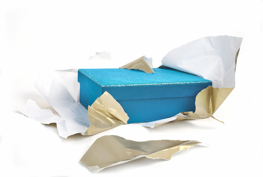 A blue box half unwrapped from gold paper Photograph by Chrisboy2004