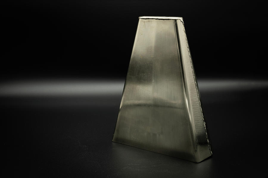 A Bongo Bell Standing On A Black Background Photograph