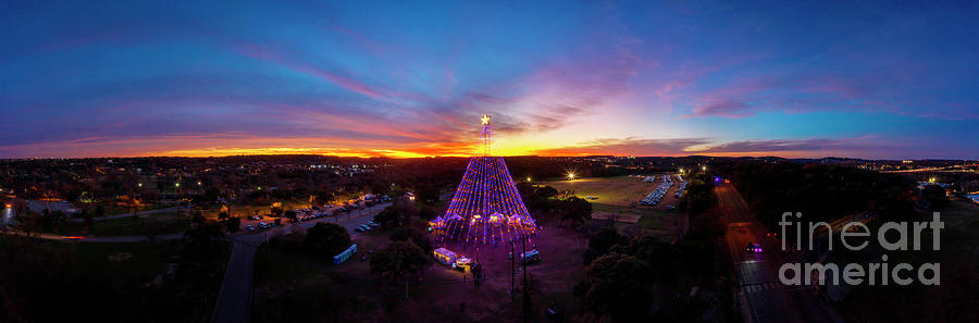 Austin Photograph - A bright lone star atop the Zilker Holiday Tree illuminates the night sky over Zilker Park by Dan Herron