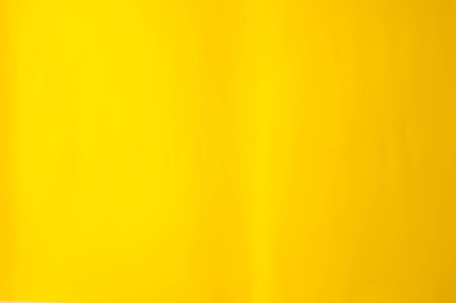 A bright yellow paper background Photograph by Karl Tapales