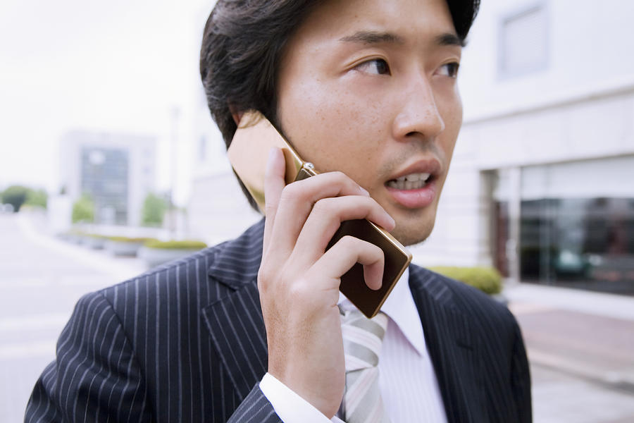 A Business Man Talking On Cell Phone Photograph by Kohei Hara