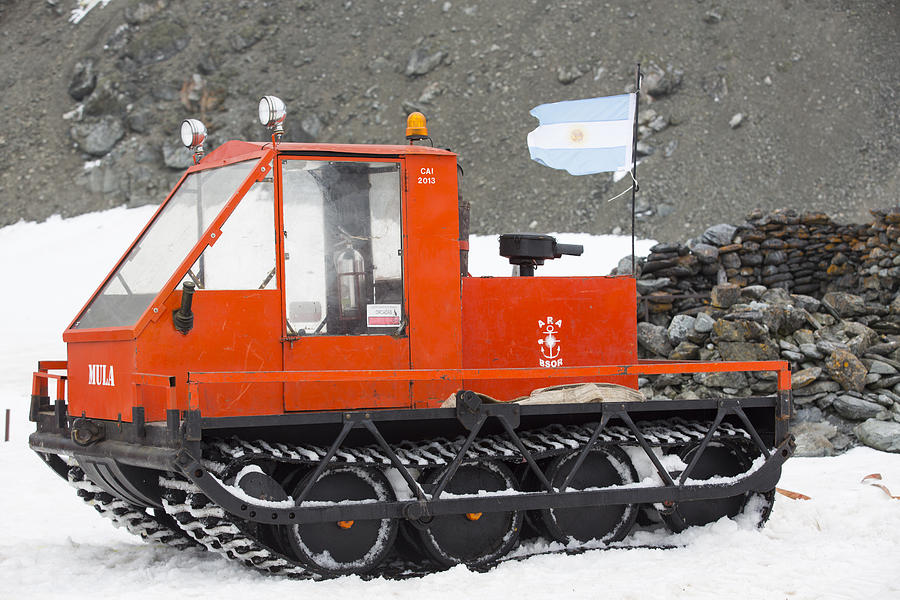 A caterpillar tracked vehicle at Base Orcadas which is an Argentine scientific station in Antarctica Photograph by Ashley Cooper