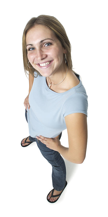 A Caucasian Female Teen In Jeans And A Blue Shirt Smiles Up At The Camera Photograph by Photodisc