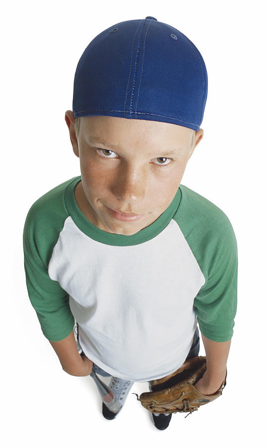 A Caucasian Male Preteen In A Green And White Shirt And Blue Cap Holds His Mitt And Smirks Looking Up Towards The Camera Photograph by Photodisc