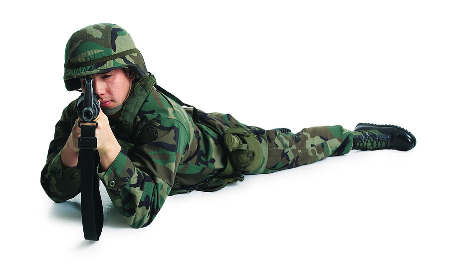 A Caucasian Male Soldier Lies On The Ground And Aims His Rifle Photograph by Photodisc