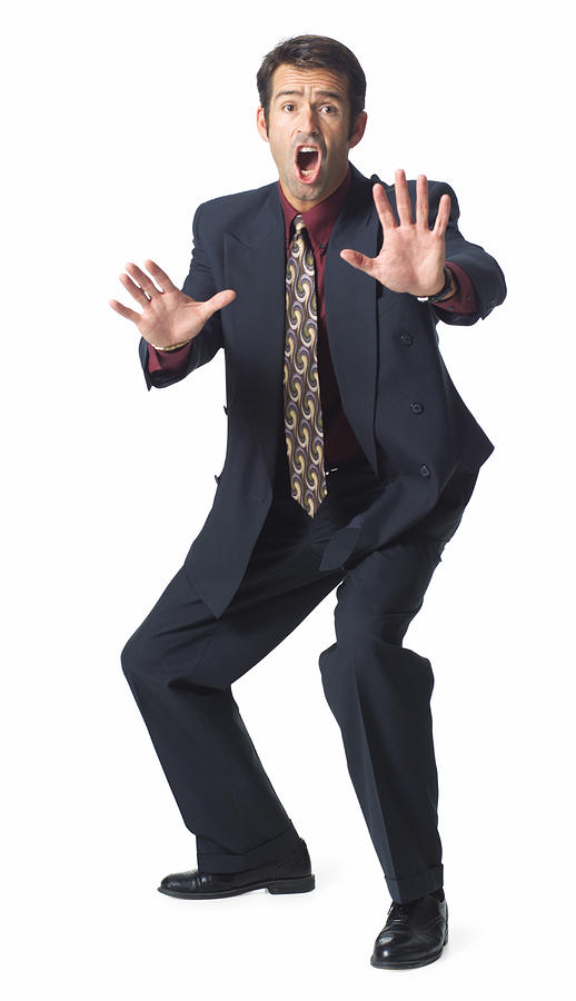 A Caucasian Man In A Grey Suit And Red Shirt Throws Up His Arms And Yells Stop Photograph by Photodisc