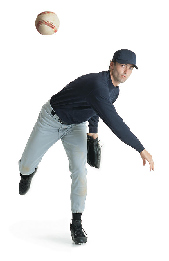 A Caucasian Man Wearing A Blue And White Baseball Uniform Is Leaning Forward After Throwing A Ball Photograph by Photodisc