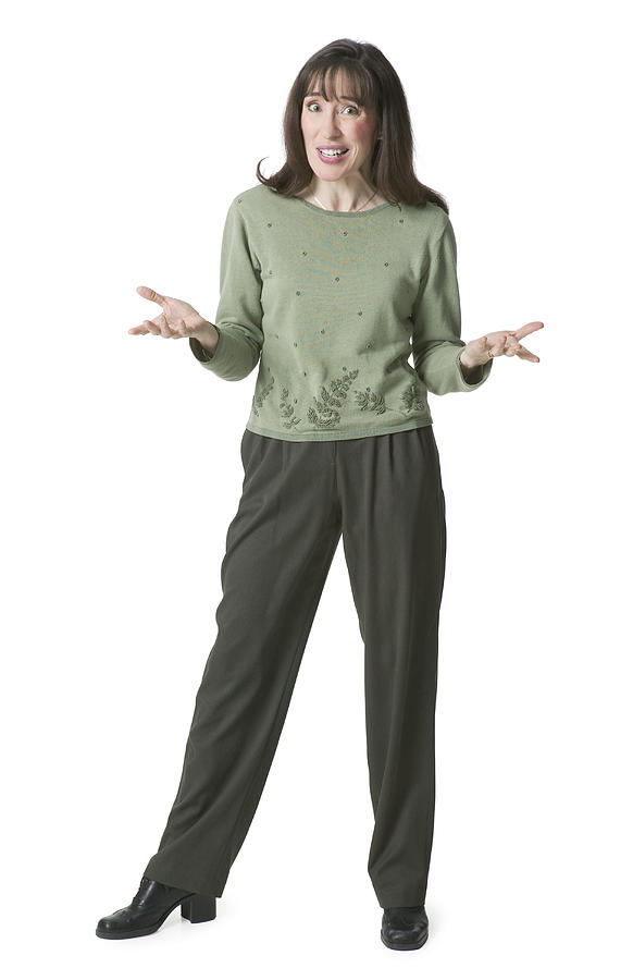 A Caucasian Woman Dressed In Green Pants And Blouse Shrugs Her Shoulders And Gestures With Her Hands Photograph by Photodisc