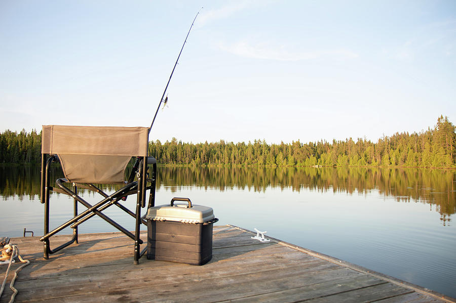 A Chair on a Wooden Dock Looking Out on a Lake in Summer with Fishing  Equipment by Ashley Swanson