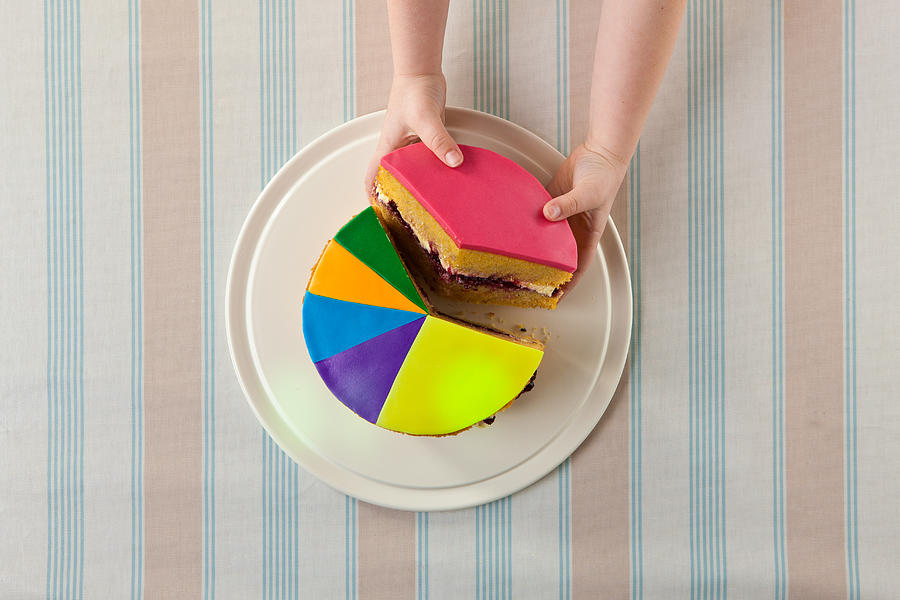 A child takes slice of a pie chart cake. Photograph by Tim Platt