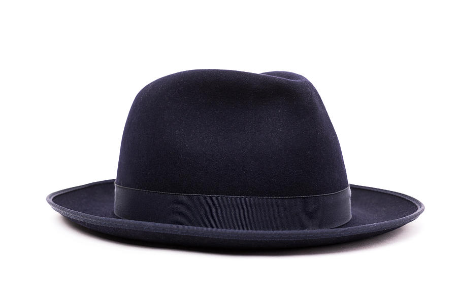 A classic low crown fedora hat in a dark blue color. Isolated on white background. Photograph by Yevgen Romanenko