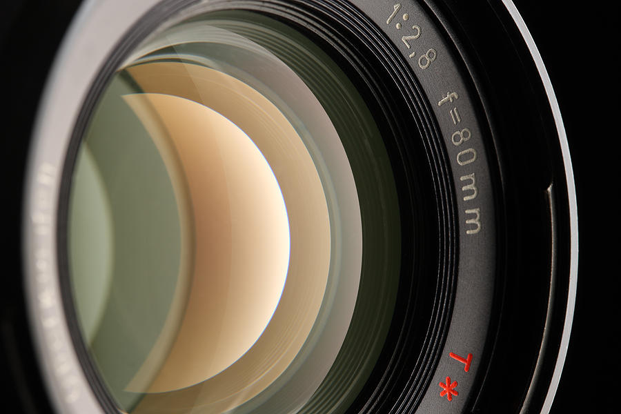A close-up of a camera lens on a black background Photograph by Kgfoto