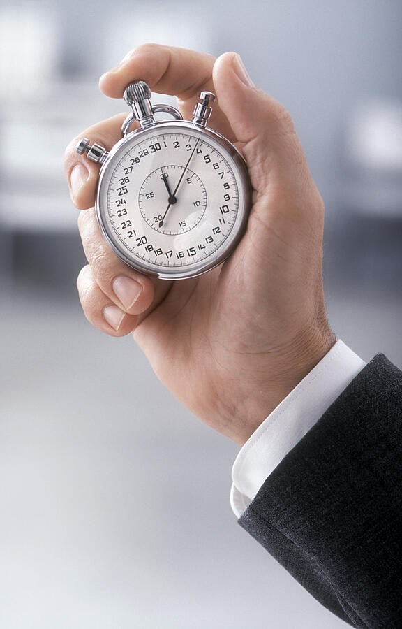 A close-up of someone holding a stopwatch Photograph by Acilo